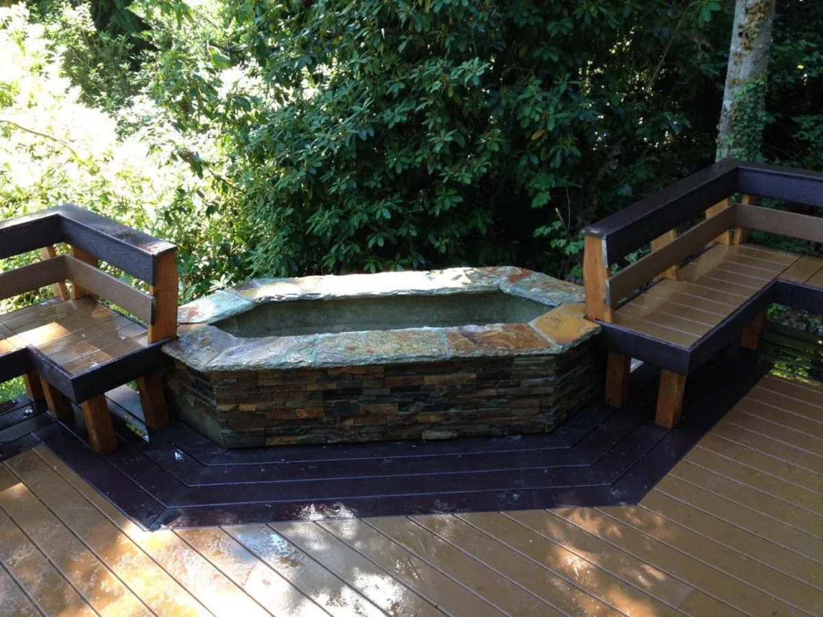 Deck with built-in fire pit by Northwoods Construction